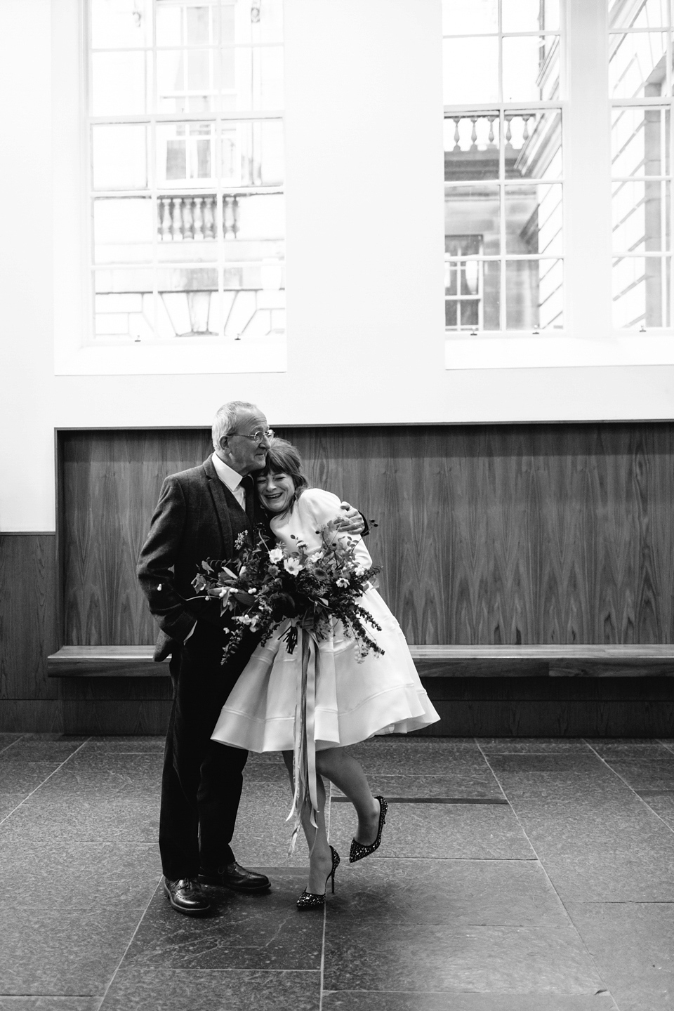 Lizzie wore a 1960's inspired short dress by Delphine Manivet for her intimate wedding in Edinburgh. Photography by Caro Weiss.