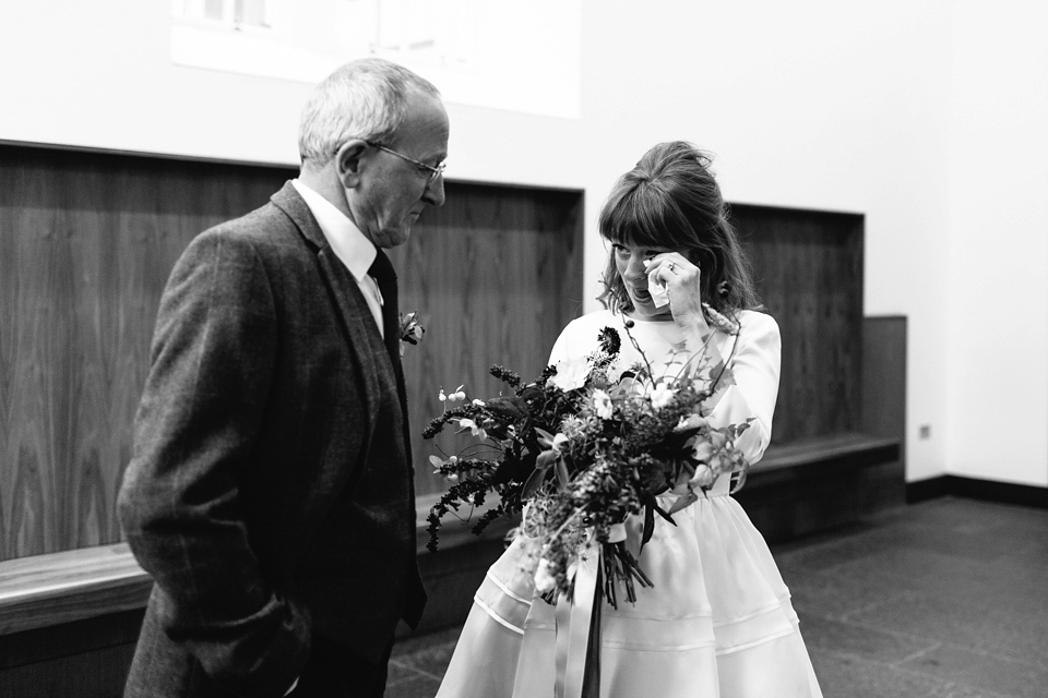 Lizzie wore a 1960's inspired short dress by Delphine Manivet for her intimate wedding in Edinburgh. Photography by Caro Weiss.