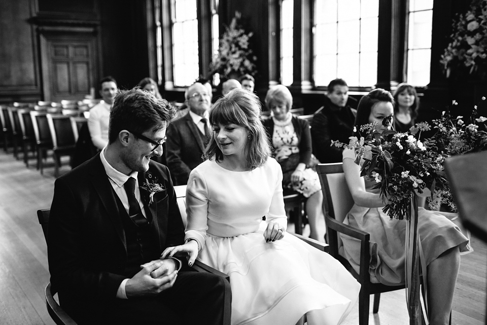 Lizzie wore a 1960's inspired short dress by Delphine Manivet for her intimate wedding in Edinburgh. Photography by Caro Weiss.