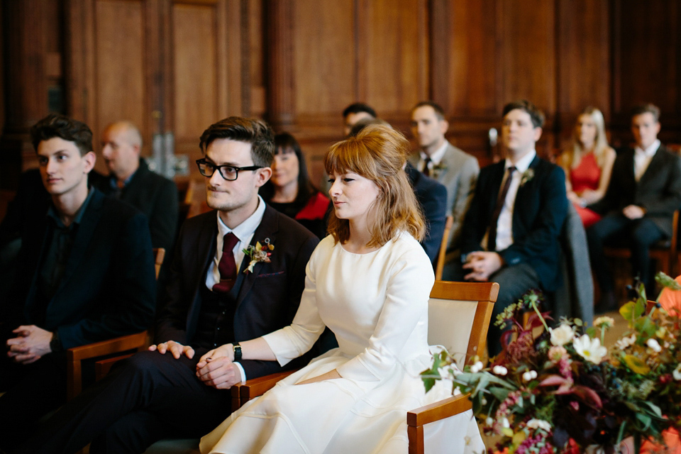 Lizzie wore a 1960's inspired short dress by Delphine Manivet for her intimate wedding in Edinburgh. Photography by Caro Weiss.