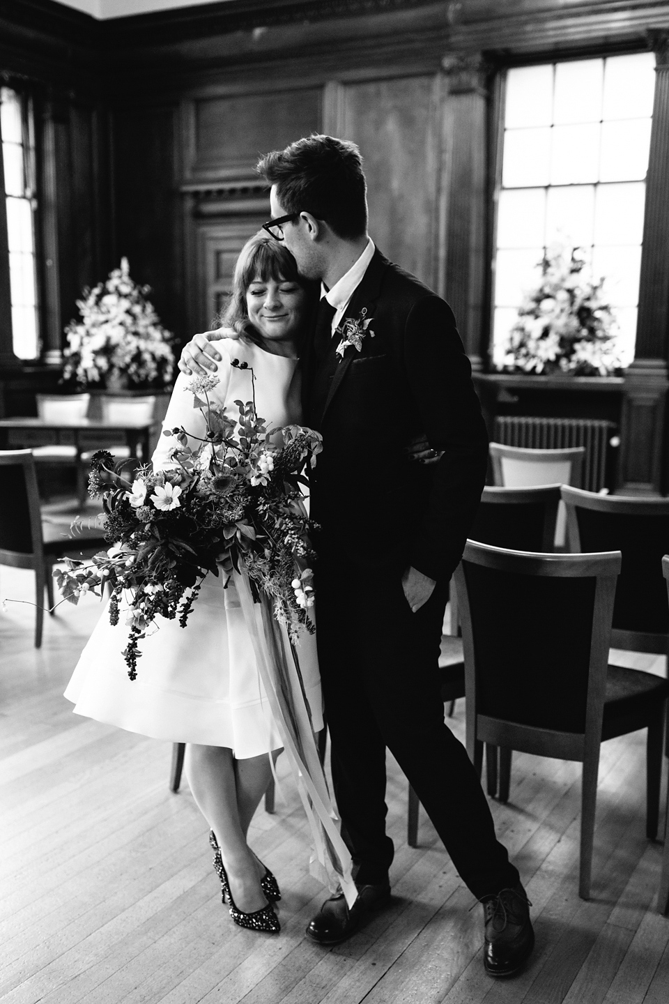 Lizzie wore a 1960's inspired short dress by Delphine Manivet for her intimate wedding in Edinburgh. Photography by Caro Weiss.