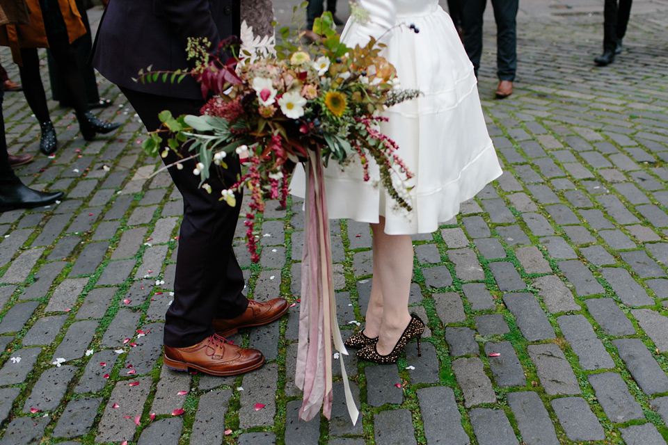 Lizzie wore a 1960's inspired short dress by Delphine Manivet for her intimate wedding in Edinburgh. Photography by Caro Weiss.