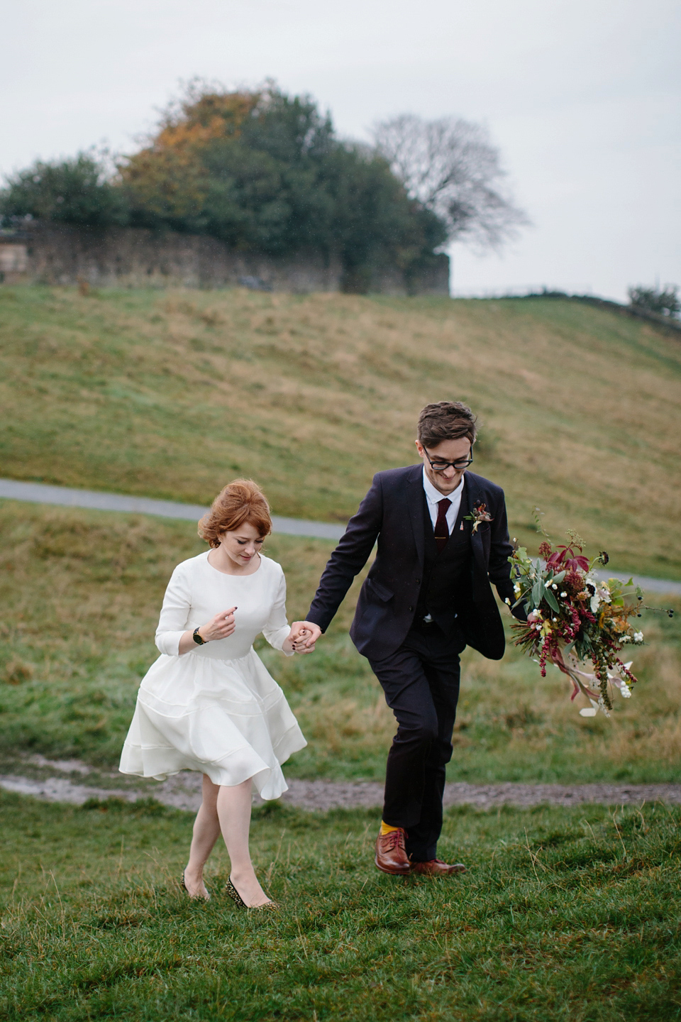 Lizzie wore a 1960's inspired short dress by Delphine Manivet for her intimate wedding in Edinburgh. Photography by Caro Weiss.