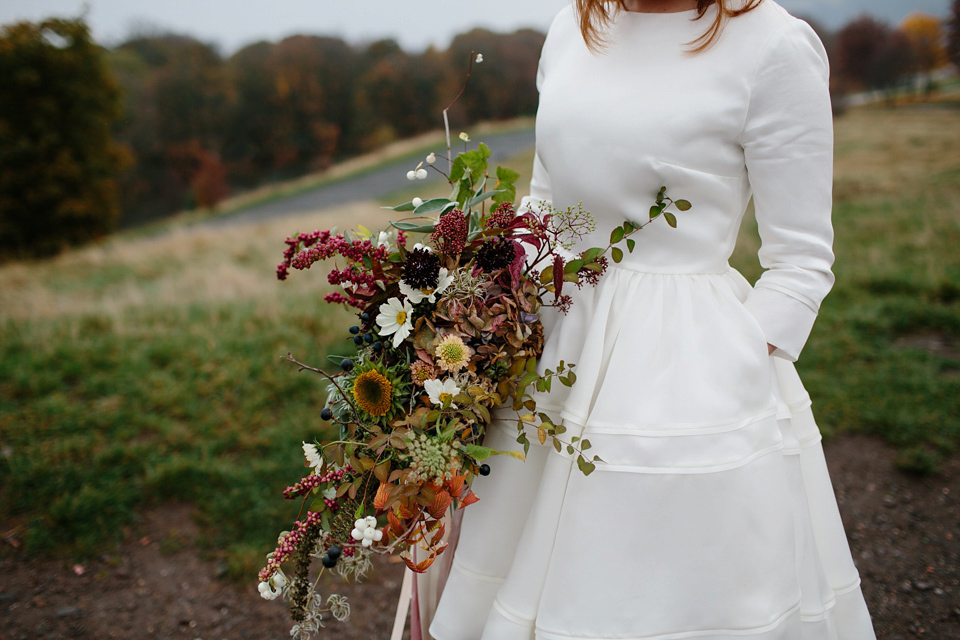 Lizzie wore a 1960's inspired short dress by Delphine Manivet for her intimate wedding in Edinburgh. Photography by Caro Weiss.