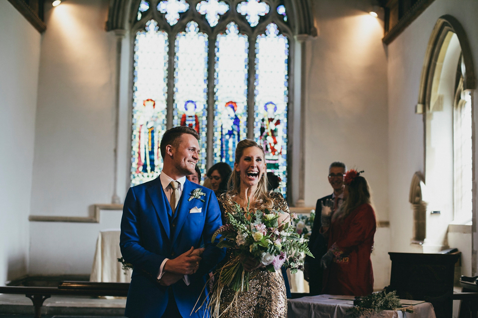 Rah wore a gold sequin wedding dress for her Suffolk barn wedding with a twist. Photography by Emily Brittain.