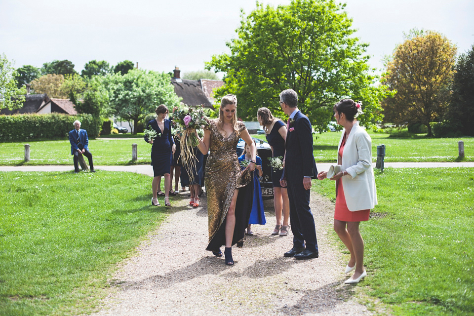 Rah wore a gold sequin wedding dress for her Suffolk barn wedding with a twist. Photography by Emily Brittain.