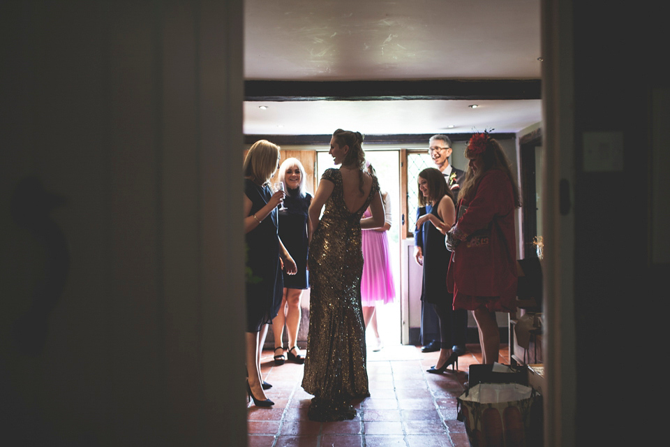 Rah wore a gold sequin wedding dress for her Suffolk barn wedding with a twist. Photography by Emily Brittain.