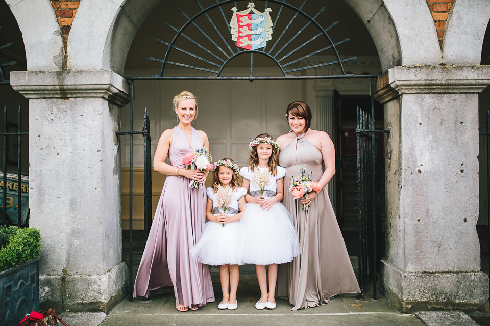 Becki wears an Ivy and Aster gown and Emmy London shoes and a draped art-deco inspired headpiece for her vintage inspried wedding at the George in Rye. Photography by Parkershots.