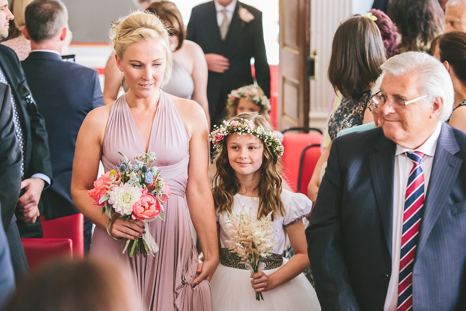 Becki wears an Ivy and Aster gown and Emmy London shoes and a draped art-deco inspired headpiece for her vintage inspried wedding at the George in Rye. Photography by Parkershots.