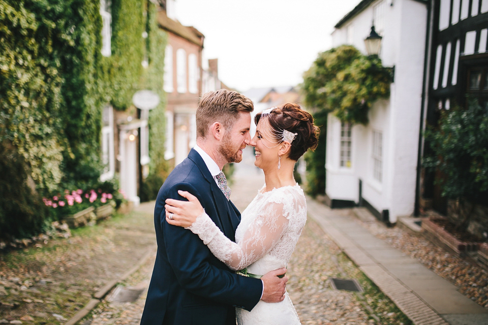 Becki wears an Ivy and Aster gown and Emmy London shoes and a draped art-deco inspired headpiece for her vintage inspried wedding at the George in Rye. Photography by Parkershots.