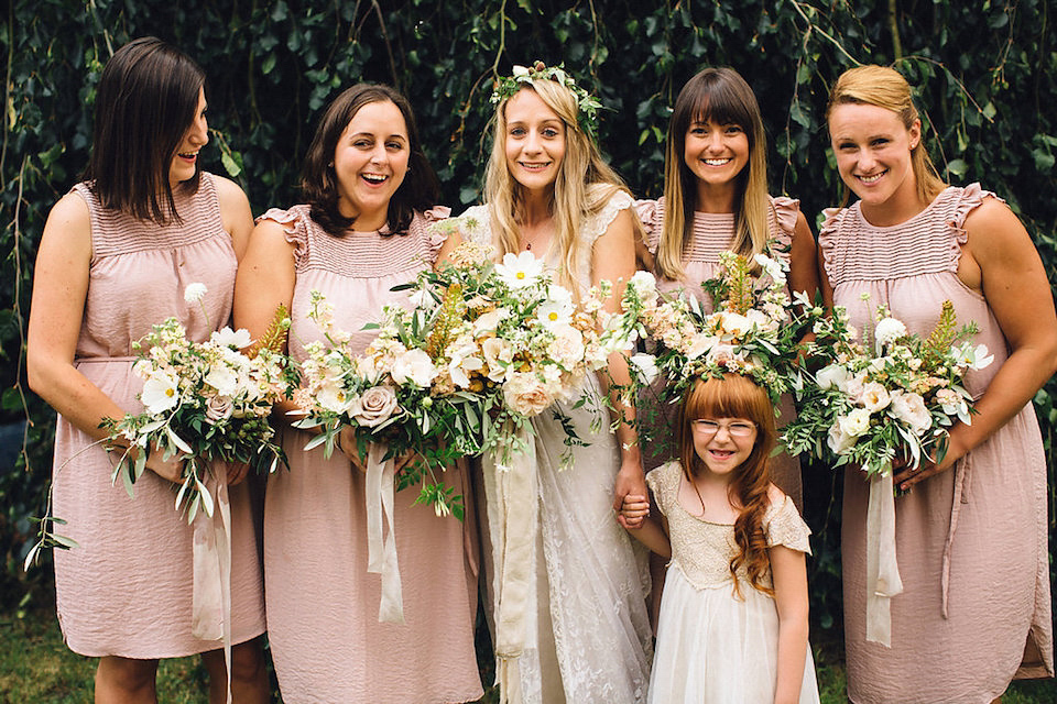 Bride Hannah wore a delicate lace gown by designer Jane Bourvis for her rustic and whimsical woodland wedding. Photography by Red on Blonde.