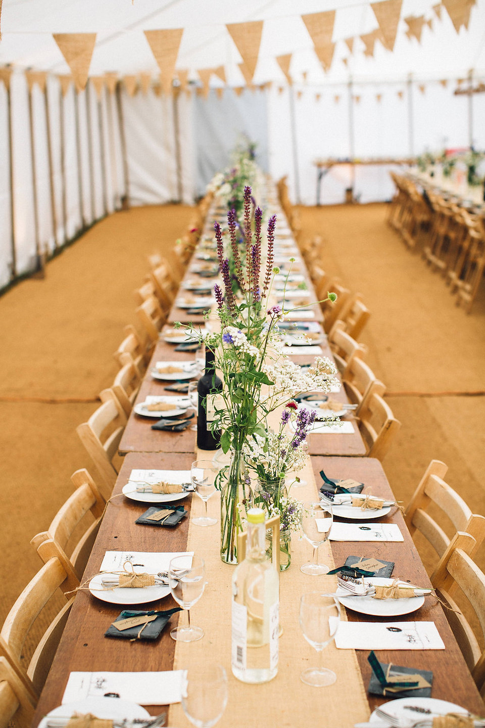 Bride Hannah wore a delicate lace gown by designer Jane Bourvis for her rustic and whimsical woodland wedding. Photography by Red on Blonde.