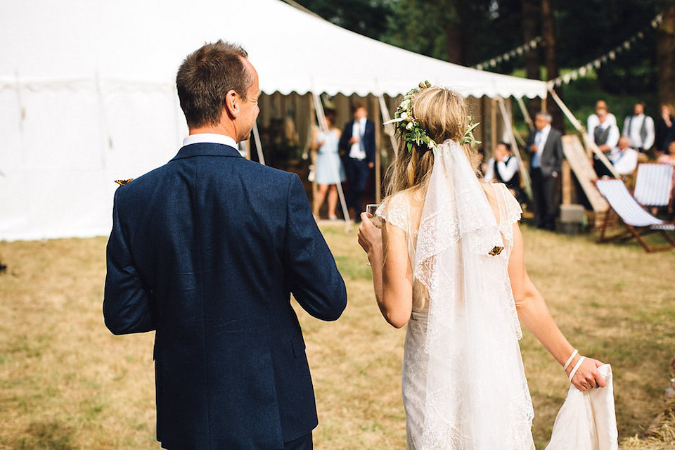 Bride Hannah wore a delicate lace gown by designer Jane Bourvis for her rustic and whimsical woodland wedding. Photography by Red on Blonde.