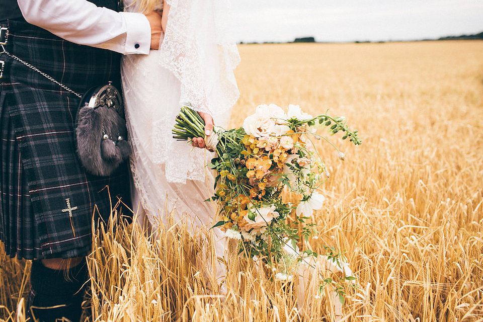 Bride Hannah wore a delicate lace gown by designer Jane Bourvis for her rustic and whimsical woodland wedding. Photography by Red on Blonde.