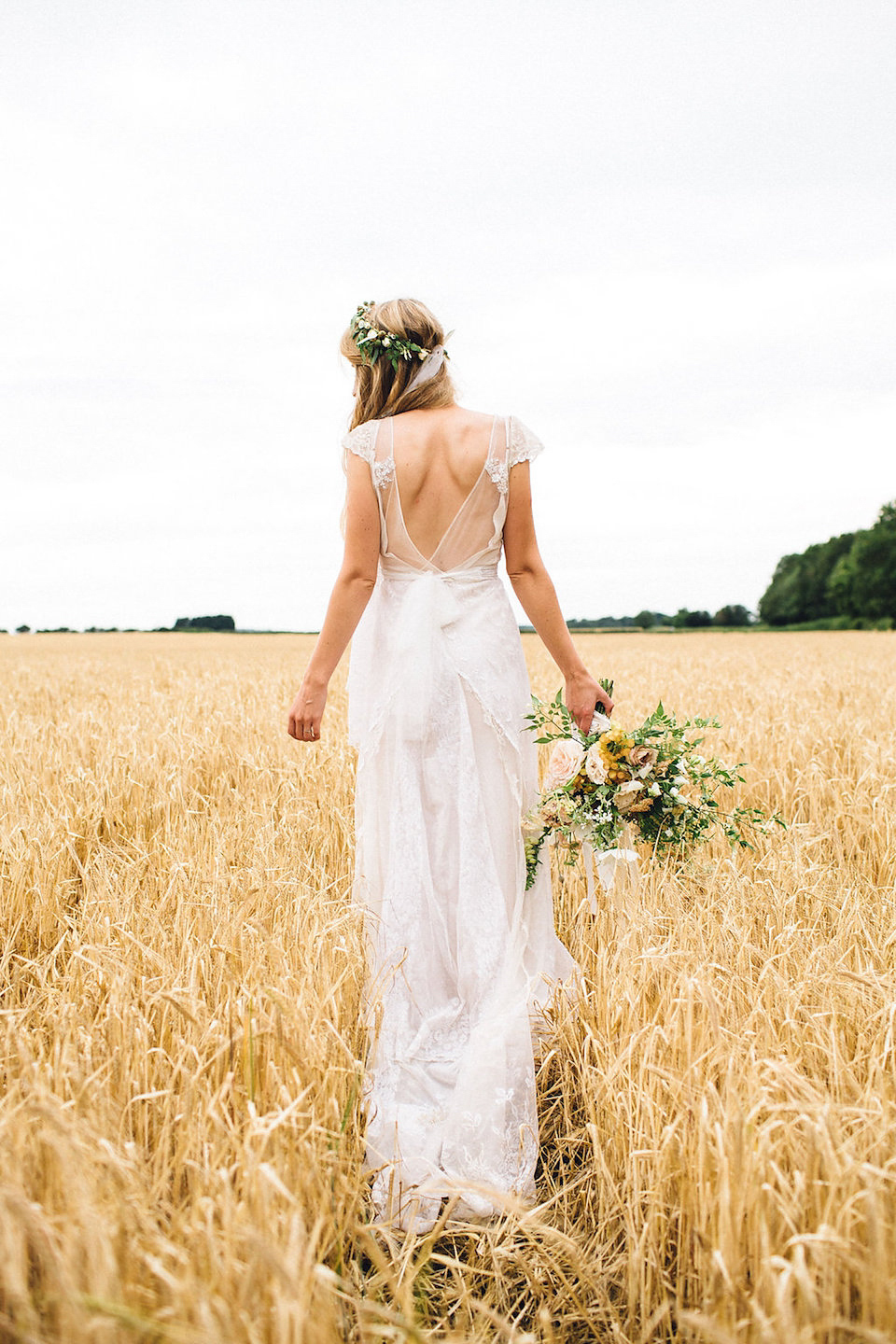 Bride Hannah wore a delicate lace gown by designer Jane Bourvis for her rustic and whimsical woodland wedding. Photography by Red on Blonde.