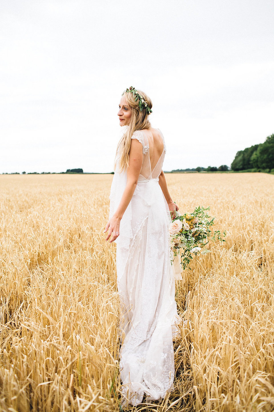 Bride Hannah wore a delicate lace gown by designer Jane Bourvis for her rustic and whimsical woodland wedding. Photography by Red on Blonde.