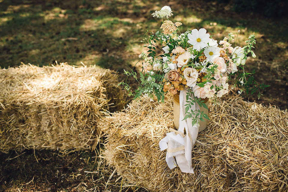 Bride Hannah wore a delicate lace gown by designer Jane Bourvis for her rustic and whimsical woodland wedding. Photography by Red on Blonde.