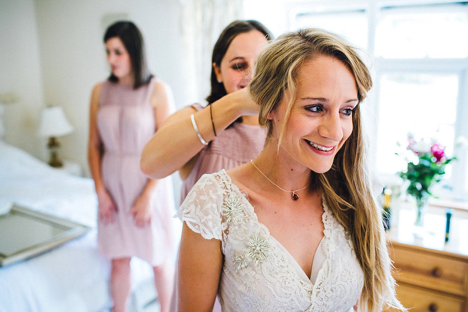 Bride Hannah wore a delicate lace gown by designer Jane Bourvis for her rustic and whimsical woodland wedding. Photography by Red on Blonde.