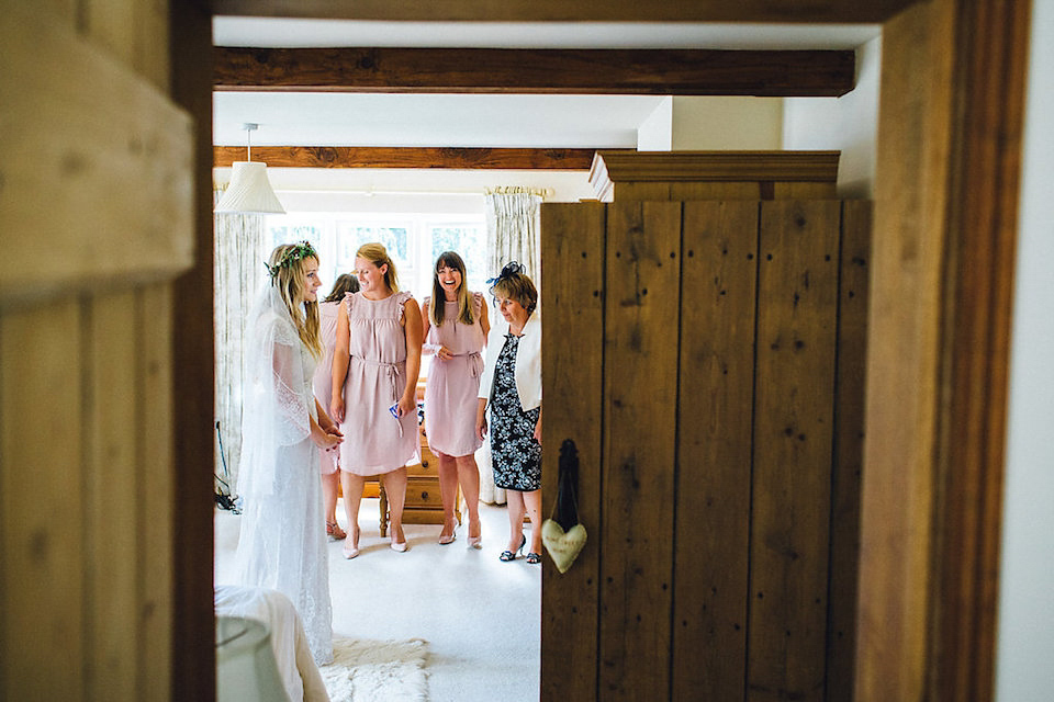 Bride Hannah wore a delicate lace gown by designer Jane Bourvis for her rustic and whimsical woodland wedding. Photography by Red on Blonde.