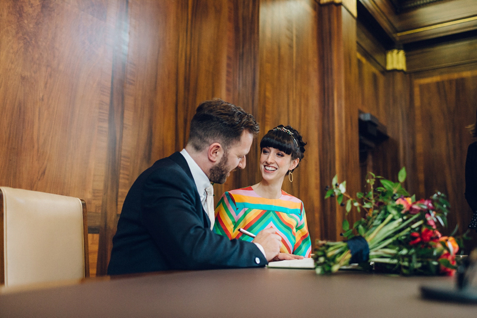 Megan wears a colourful rainbow Valentino gown for her cool and quirky London pub wedding. Photography by Lee Garland.