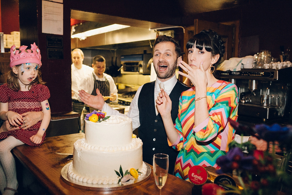 Megan wears a colourful rainbow Valentino gown for her cool and quirky London pub wedding. Photography by Lee Garland.