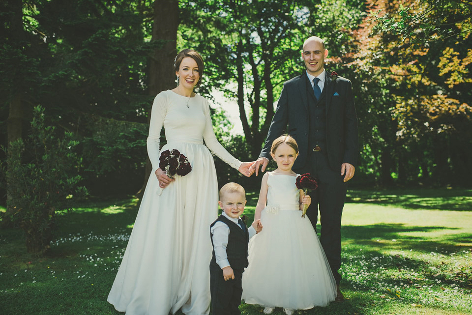 A long sleeved 1950's inspired wedding dress handmade by the bride herself. Photography by Paula Gillespie.
