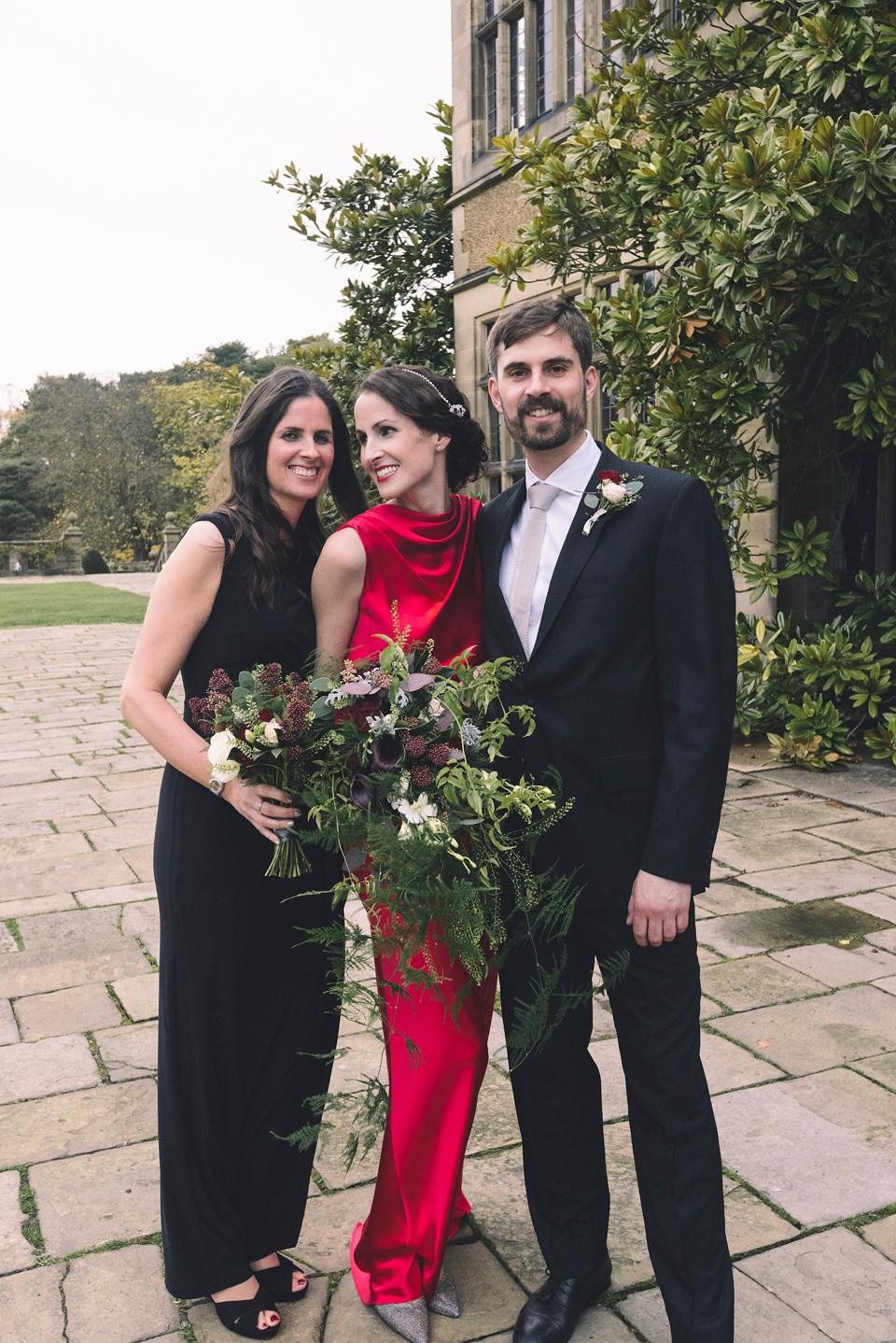 Nicola wears a red silk Amanda Wakeley dress for her glamorous Autumn wedding. Photography by Chiron Cole.