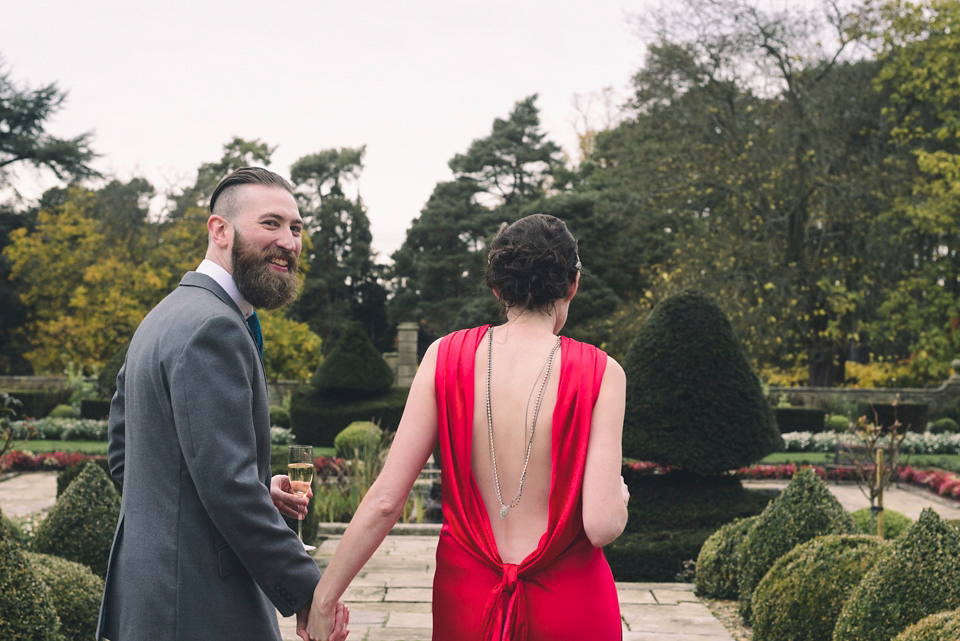 Nicola wears a red silk Amanda Wakeley dress for her glamorous Autumn wedding. Photography by Chiron Cole.
