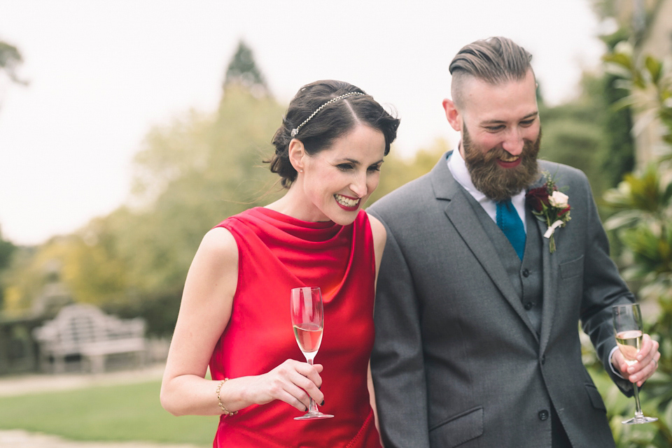 Nicola wears a red silk Amanda Wakeley dress for her glamorous Autumn wedding. Photography by Chiron Cole.