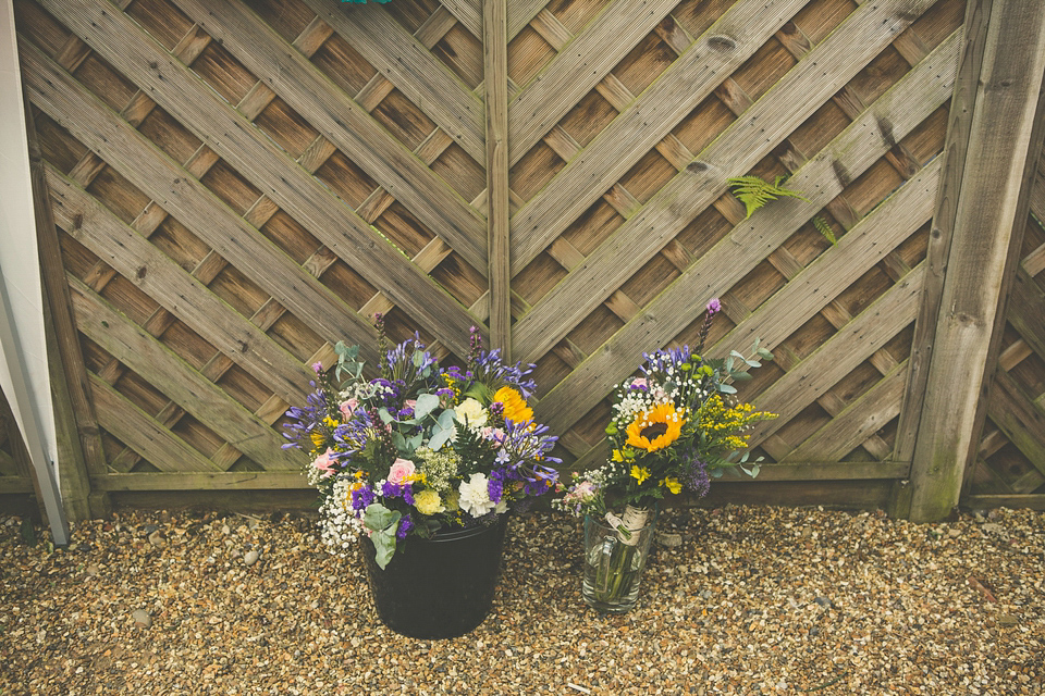 Kat wore an Oxfam wedding dress for her laid back and homemade wedding in her Mum's back garden. Photography by India Hobson.