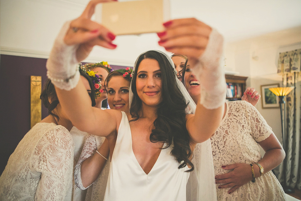 Kat wore an Oxfam wedding dress for her laid back and homemade wedding in her Mum's back garden. Photography by India Hobson.