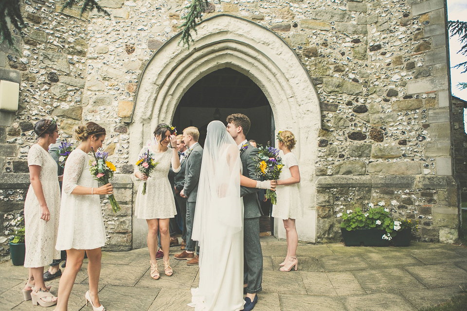 Kat wore an Oxfam wedding dress for her laid back and homemade wedding in her Mum's back garden. Photography by India Hobson.