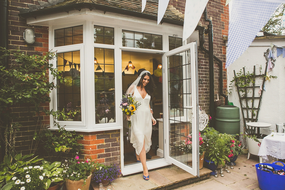 Kat wore an Oxfam wedding dress for her laid back and homemade wedding in her Mum's back garden. Photography by India Hobson.