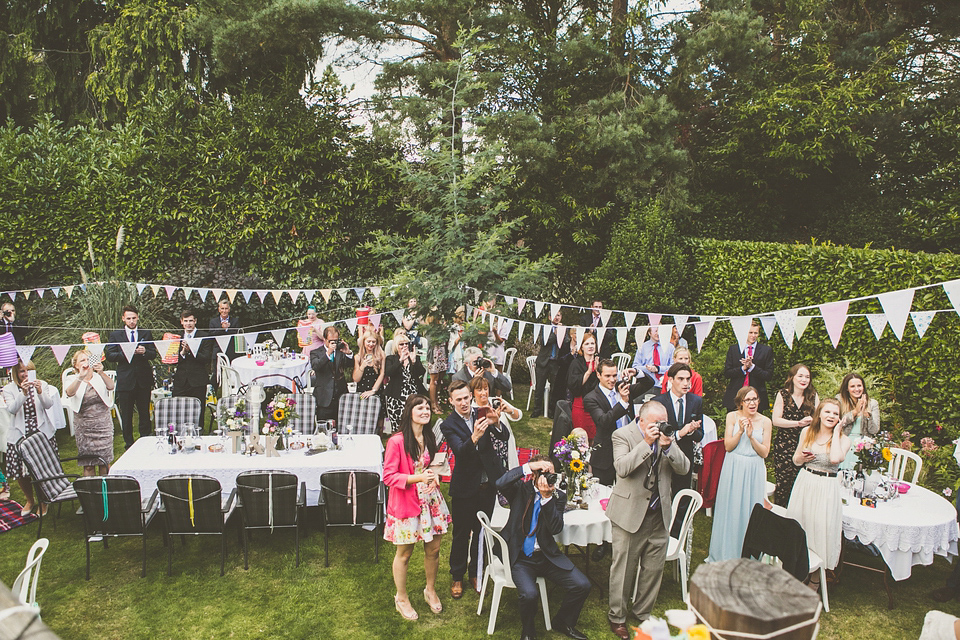 Kat wore an Oxfam wedding dress for her laid back and homemade wedding in her Mum's back garden. Photography by India Hobson.