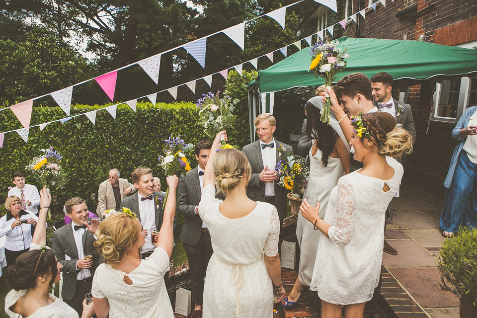 Kat wore an Oxfam wedding dress for her laid back and homemade wedding in her Mum's back garden. Photography by India Hobson.