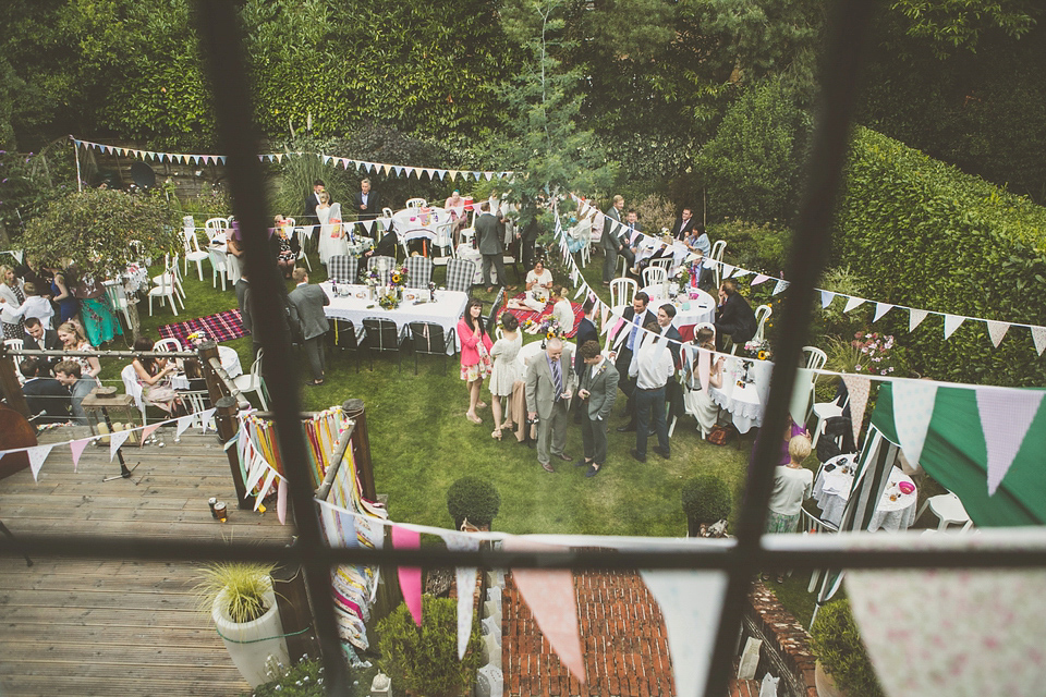 Kat wore an Oxfam wedding dress for her laid back and homemade wedding in her Mum's back garden. Photography by India Hobson.