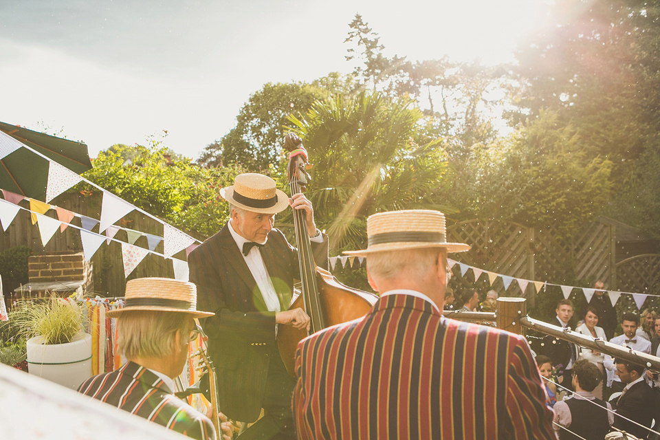 Kat wore an Oxfam wedding dress for her laid back and homemade wedding in her Mum's back garden. Photography by India Hobson.