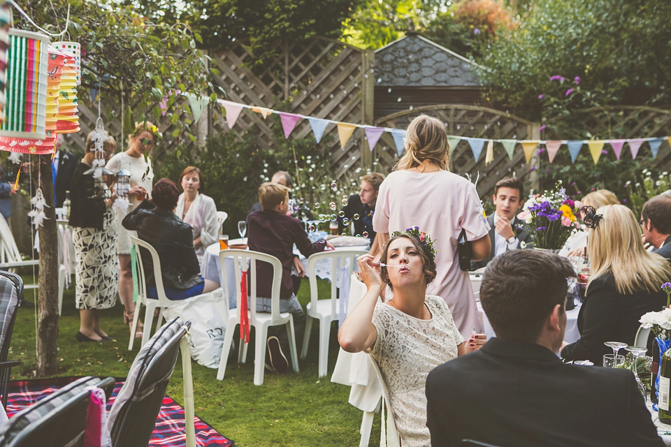 Kat wore an Oxfam wedding dress for her laid back and homemade wedding in her Mum's back garden. Photography by India Hobson.