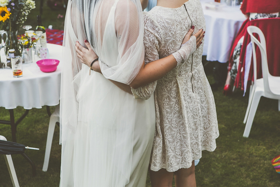 Kat wore an Oxfam wedding dress for her laid back and homemade wedding in her Mum's back garden. Photography by India Hobson.