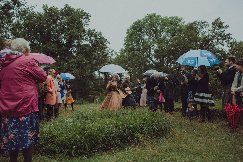 Victoria wore an alternative ballgown style dress by Aftershock for her intimate, outdoor, rainy day wedding in Scotland. Images by Drawing Room Photography.