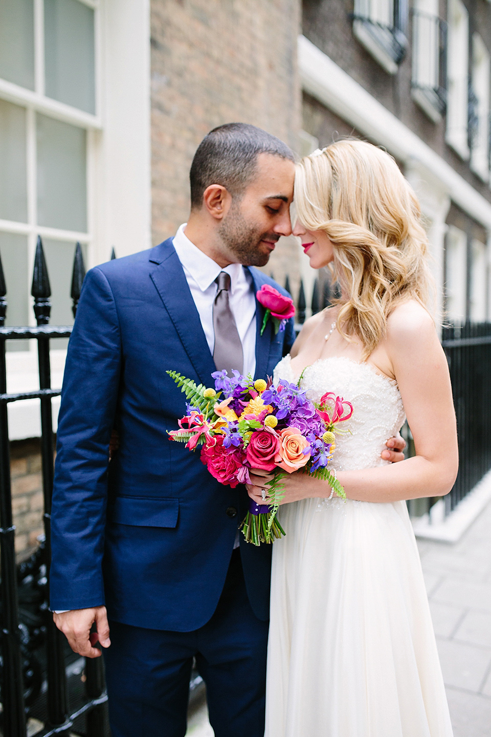 Kim wore a Leanne Marshall gown for her bright and colourful, art and science inspired wedding at RSA House in London. Photography by Hayley Savage.