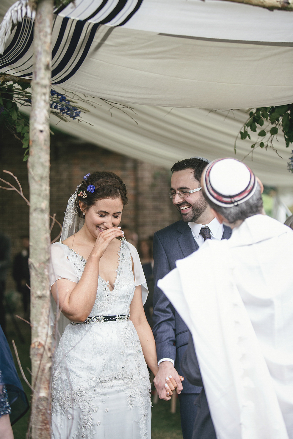 A modern Jewish wedding - the bride wears a gown by Wilden Bride. Photography by Kat Hill.