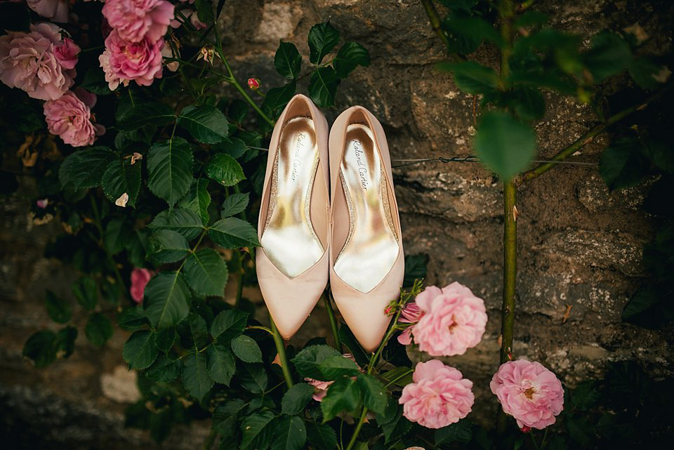 Anna wore a pale gold wedding dress designed by Jane Bourvis for her English country wedding. Photography by Lucy Greenhill.