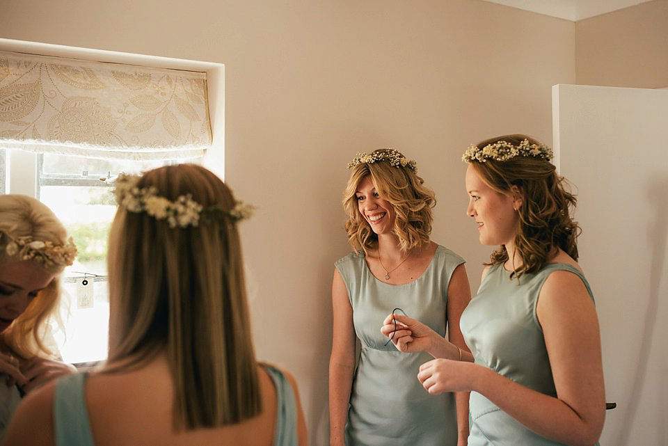 Anna wore a pale gold wedding dress designed by Jane Bourvis for her English country wedding. Photography by Lucy Greenhill.