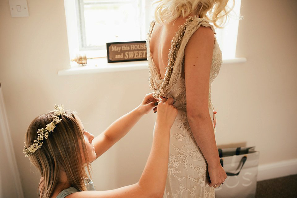 Anna wore a pale gold wedding dress designed by Jane Bourvis for her English country wedding. Photography by Lucy Greenhill.