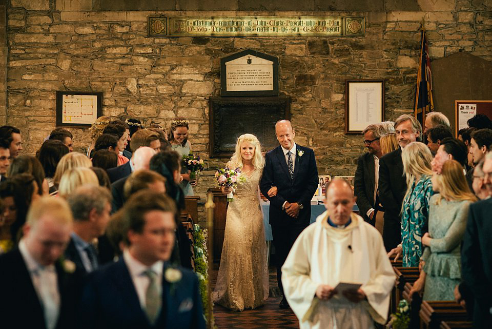 Anna wore a pale gold wedding dress designed by Jane Bourvis for her English country wedding. Photography by Lucy Greenhill.