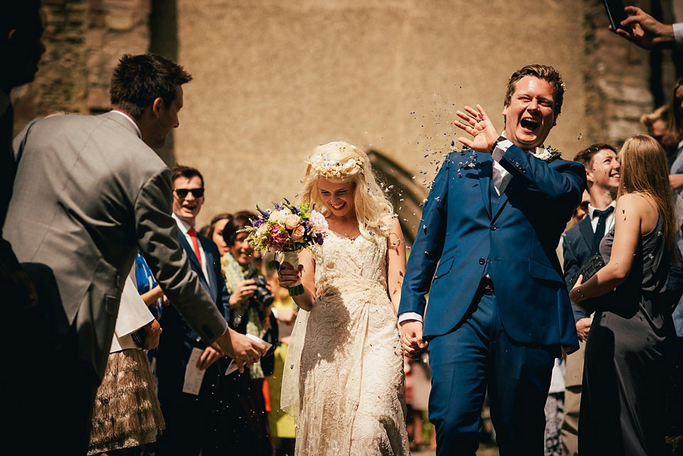 Anna wore a pale gold wedding dress designed by Jane Bourvis for her English country wedding. Photography by Lucy Greenhill.