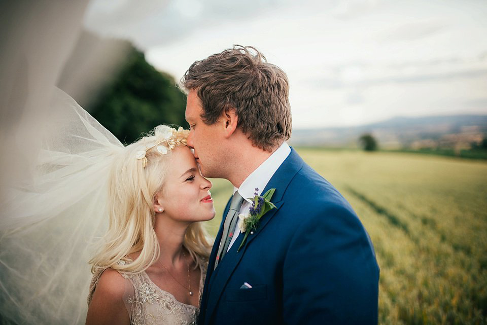 Anna wore a pale gold wedding dress designed by Jane Bourvis for her English country wedding. Photography by Lucy Greenhill.