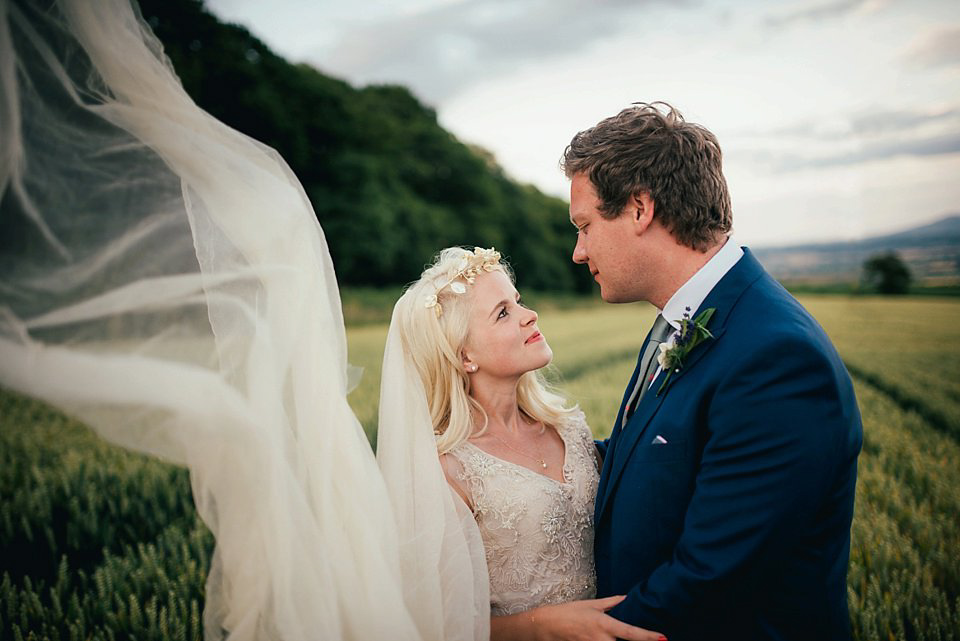 Anna wore a pale gold wedding dress designed by Jane Bourvis for her English country wedding. Photography by Lucy Greenhill.