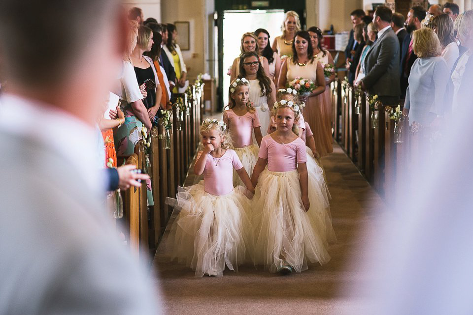 Bryony wore a gown with a floral back by Claire Pettibone from Blackburn Bridal for her Summer wedding held at her husband's family home. Photography by Kristian Leven.